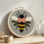 Flying bee punch needle artwork displayed on a table