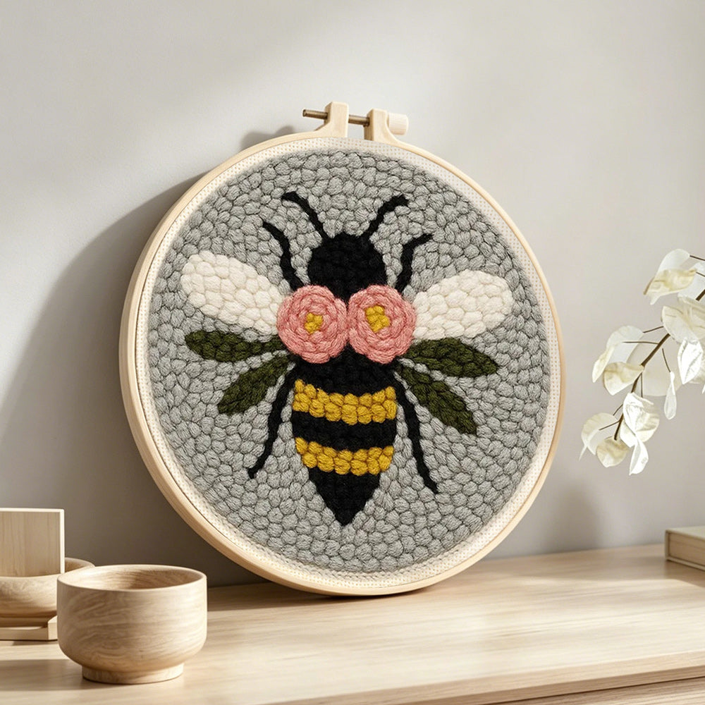Flying bee punch needle artwork displayed on a table