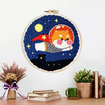 Finished flying space puppy artwork displayed on a wall