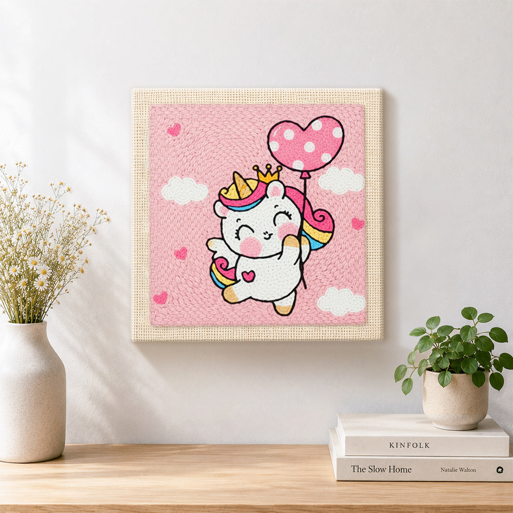 Finished flying unicorn with heart balloon artwork displayed on a wall
