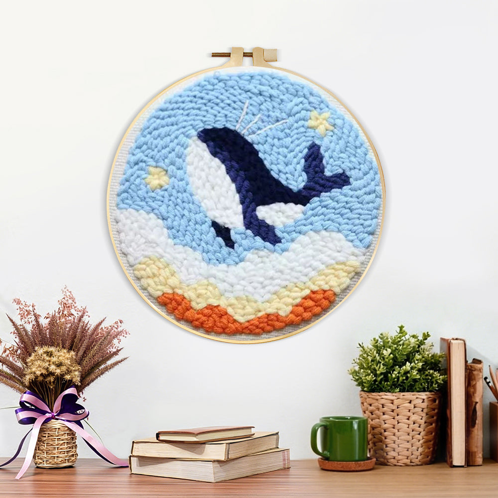 Finished flying whale in sky with stars and clouds artwork displayed on a wall