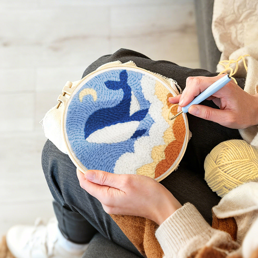Creating handmade flying whale in the sky with clouds punch needle artwork
