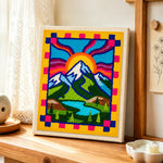 Folk art style mountains and sun rays punch needle artwork displayed on a table