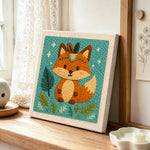 Forest prince fox with blue gem punch needle artwork displayed on a table