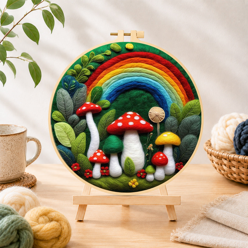 Finished forest rainbow and red mushrooms needle felting displayed on a wooden easel