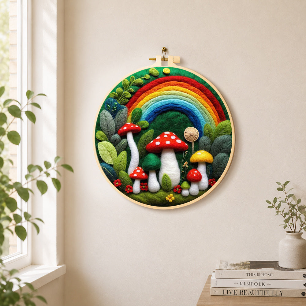 Forest rainbow and red mushrooms needle felt wall art displayed in a bright home interior