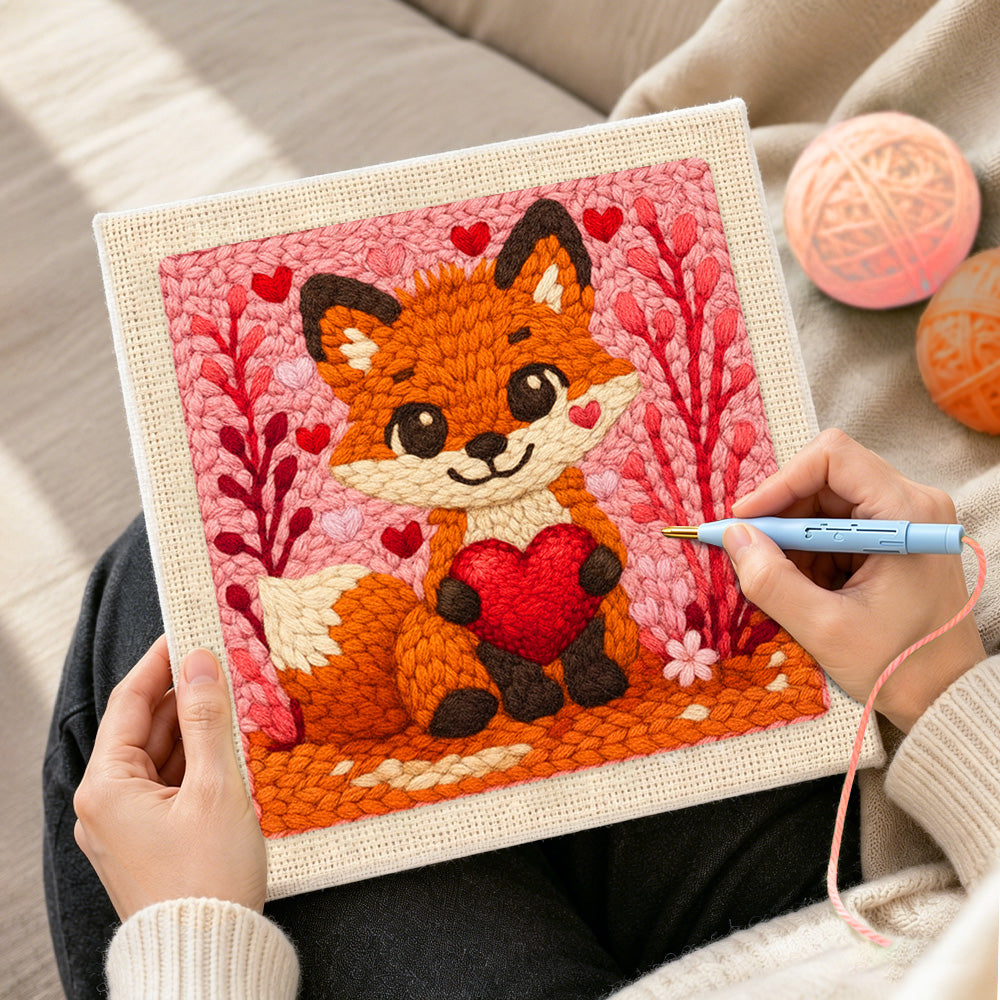 Creating handmade fox holding a red heart punch needle artwork