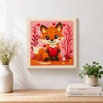 Finished fox holding a red heart artwork displayed on a wall