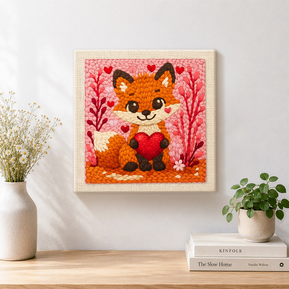 Finished fox holding a red heart artwork displayed on a wall