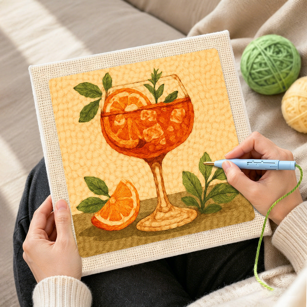 Creating handmade fresh orange spritz with mint and ice cubes punch needle artwork