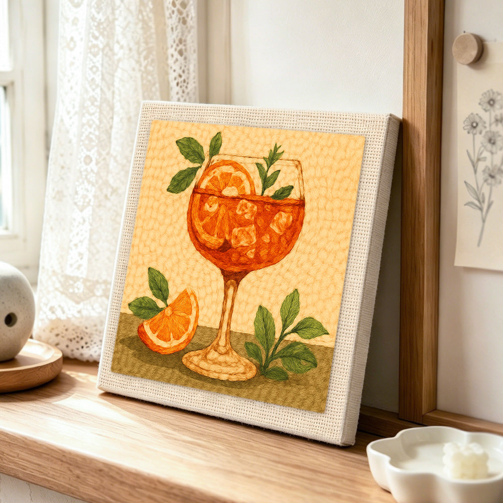 Fresh orange spritz with mint and ice cubes punch needle artwork displayed on a table