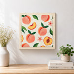 Finished fresh peaches with leaves artwork displayed on a wall