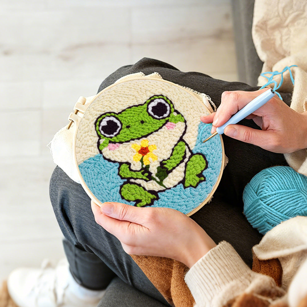 Creating handmade frog holding a flower punch needle artwork