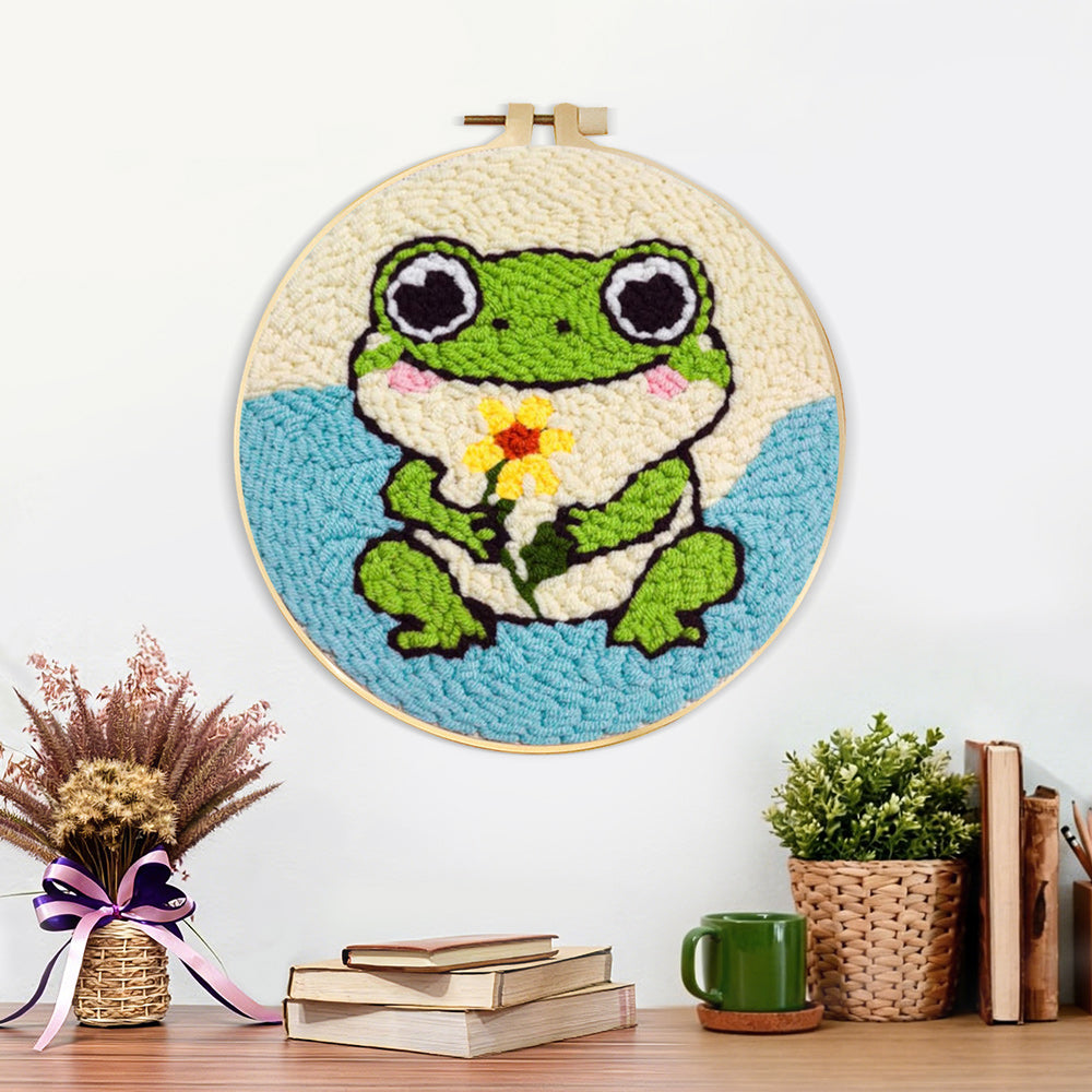 Finished frog holding a flower artwork displayed on a wall