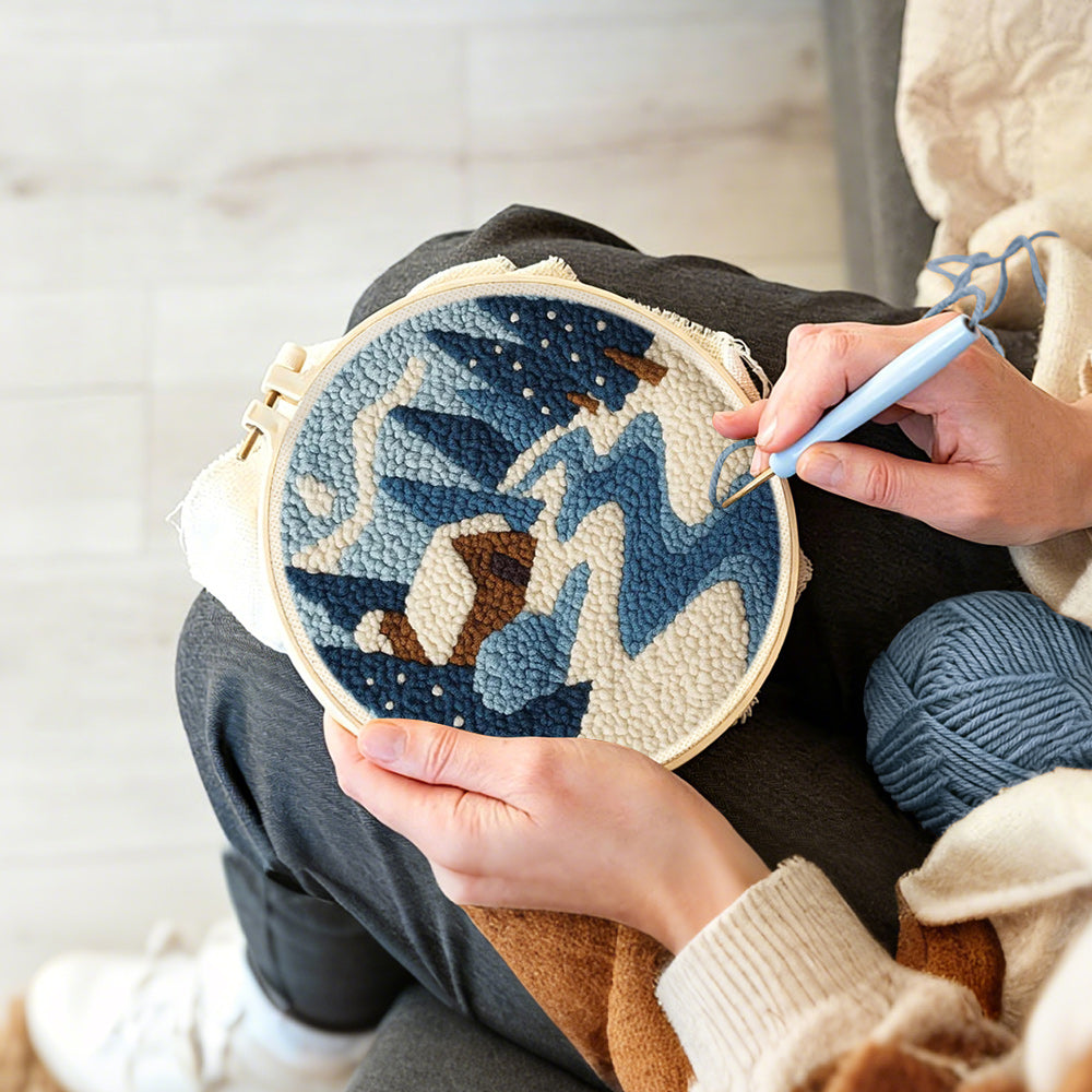 Creating handmade frozen blue forest and cosy cabin punch needle artwork