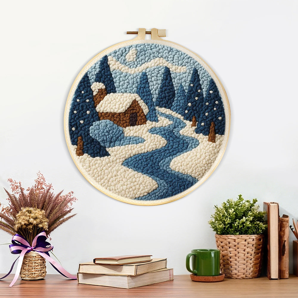 Finished frozen blue forest and cosy cabin artwork displayed on a wall