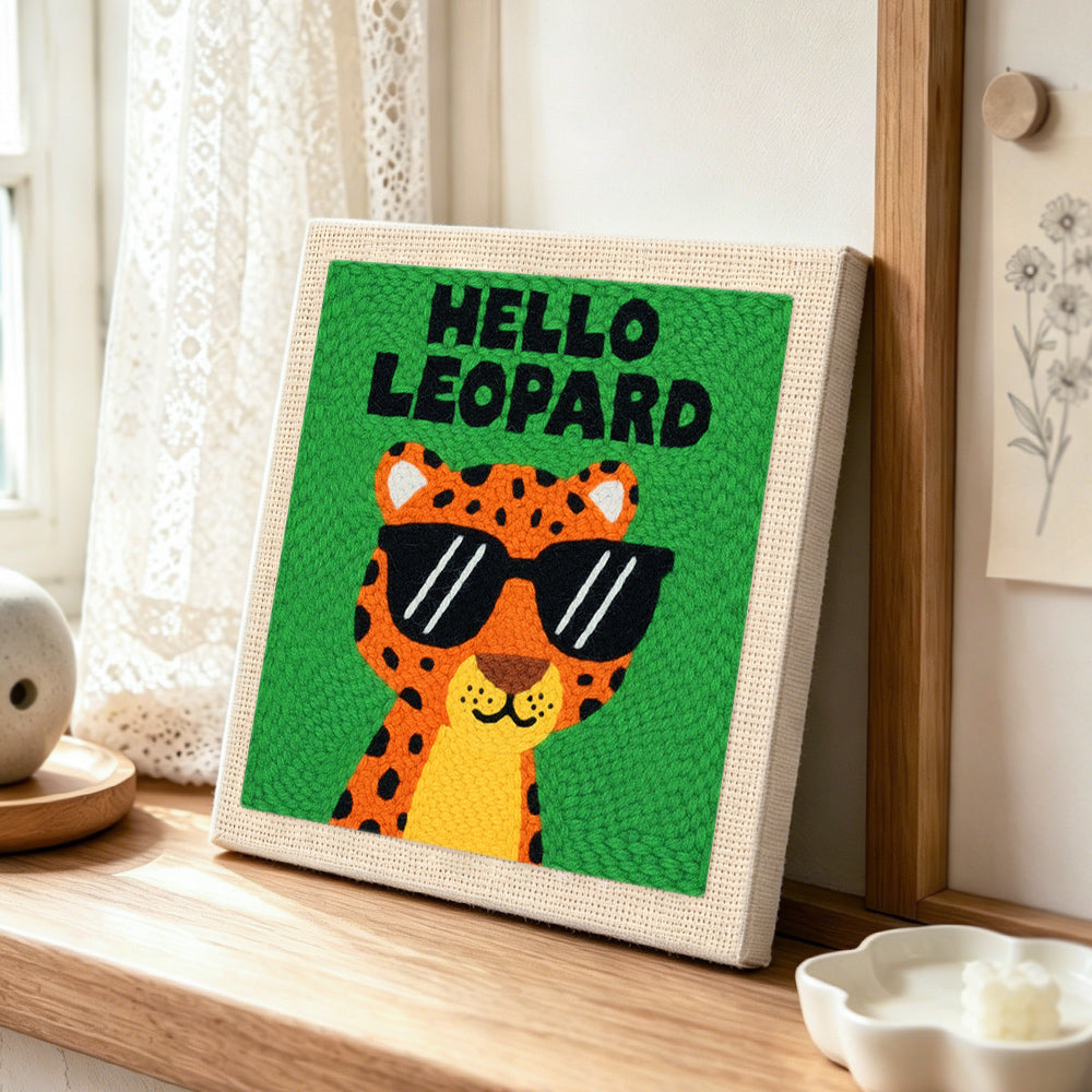 Funky "hello leopard" punch needle artwork displayed on a table