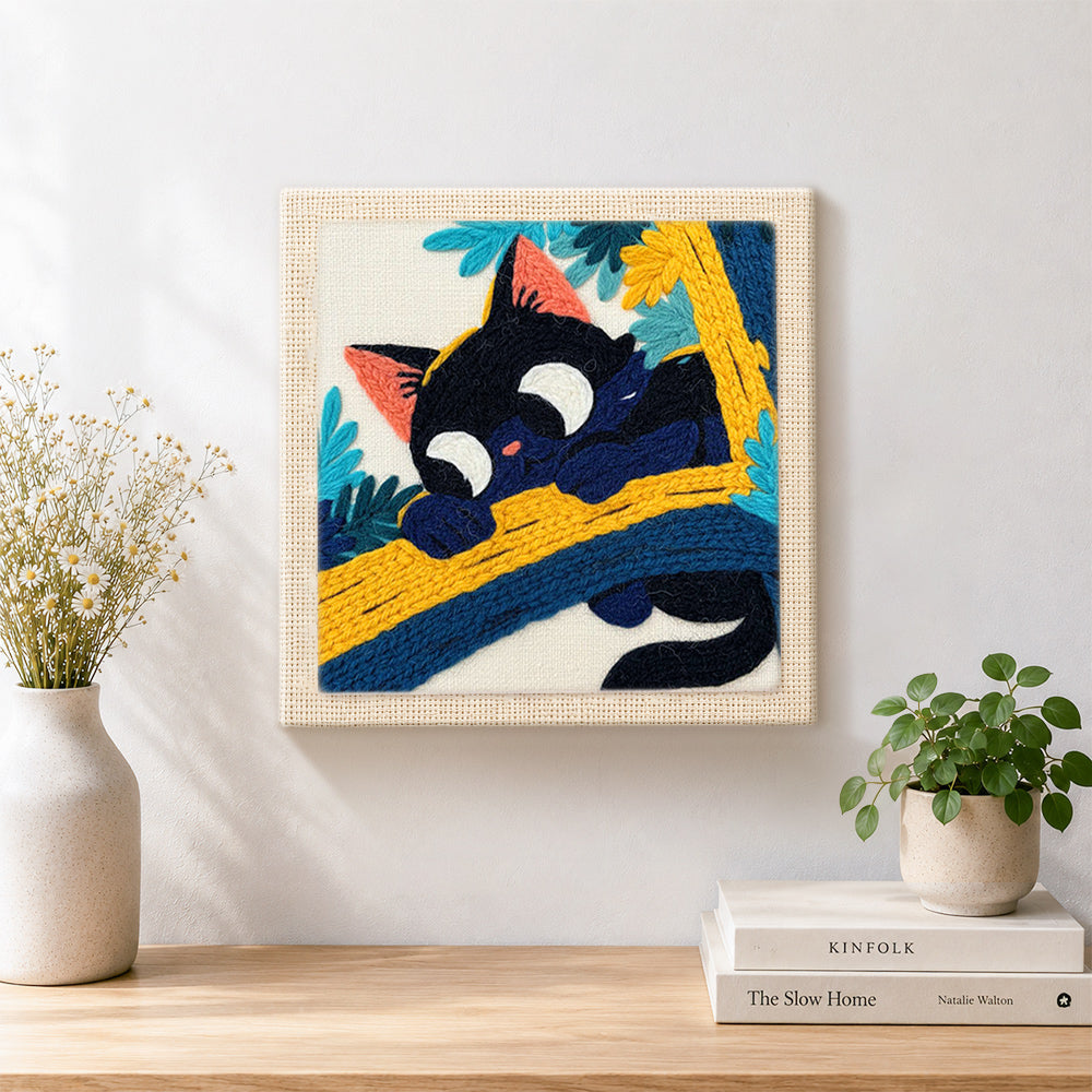 Finished funny black cat on a branch artwork displayed on a wall