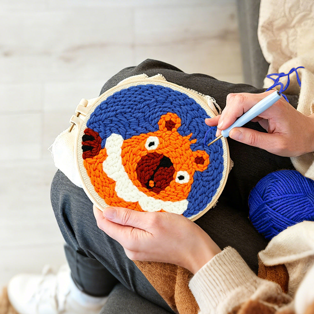 Creating handmade funny orange squirrel punch needle artwork