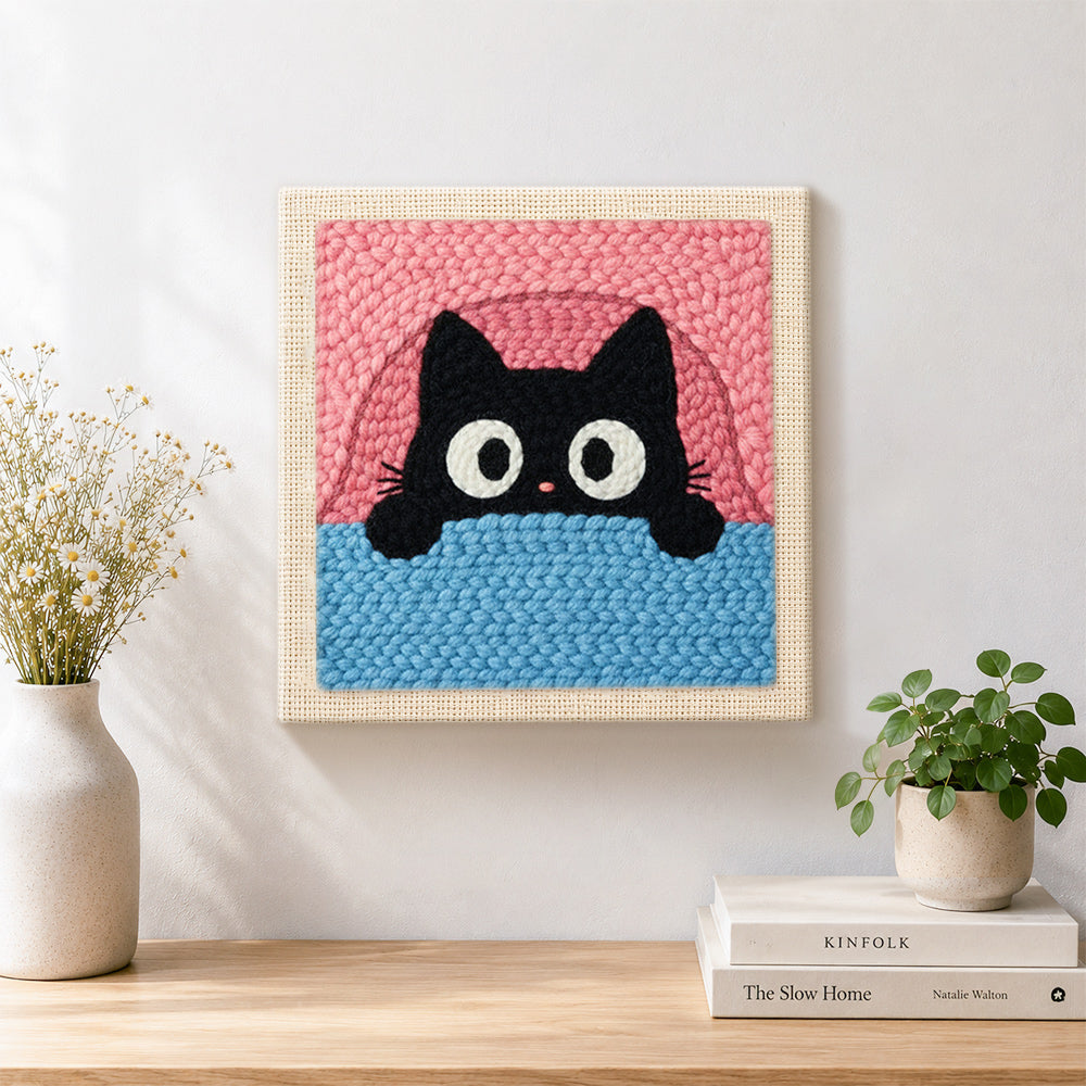 Finished funny peeking kitten artwork displayed on a wall