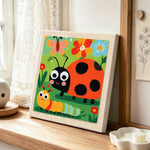 Garden friends ladybug and caterpillar punch needle artwork displayed on a table
