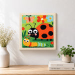 Finished garden friends ladybug and caterpillar artwork displayed on a wall