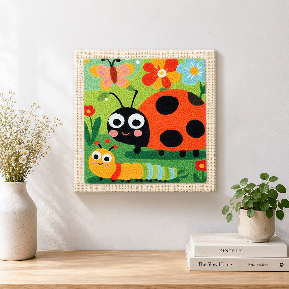 Finished garden friends ladybug and caterpillar artwork displayed on a wall