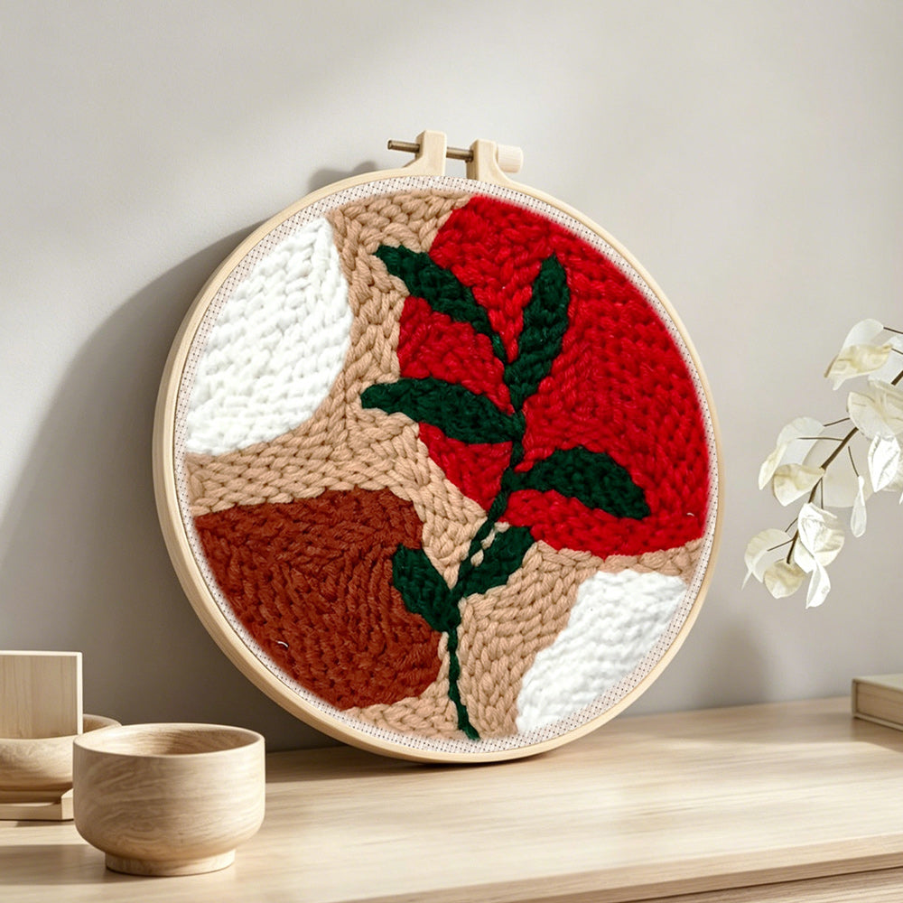 Geometric colour block with green vine punch needle artwork displayed on a table