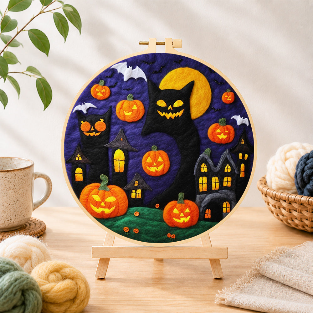 Finished giant black cat and spooky halloween pumpkins needle felting displayed on a wooden easel
