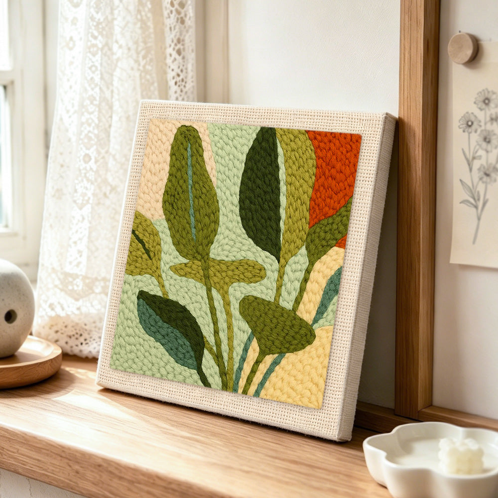 Giant botanical leaves punch needle artwork displayed on a table