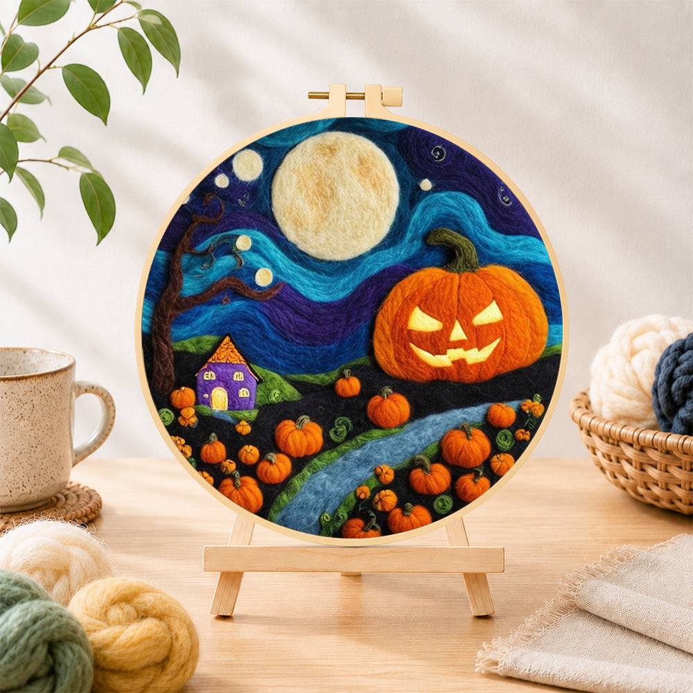 Finished giant pumpkin on halloween night needle felting displayed on a wooden easel