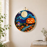 Giant pumpkin on halloween night needle felt wall art displayed in a bright home interior