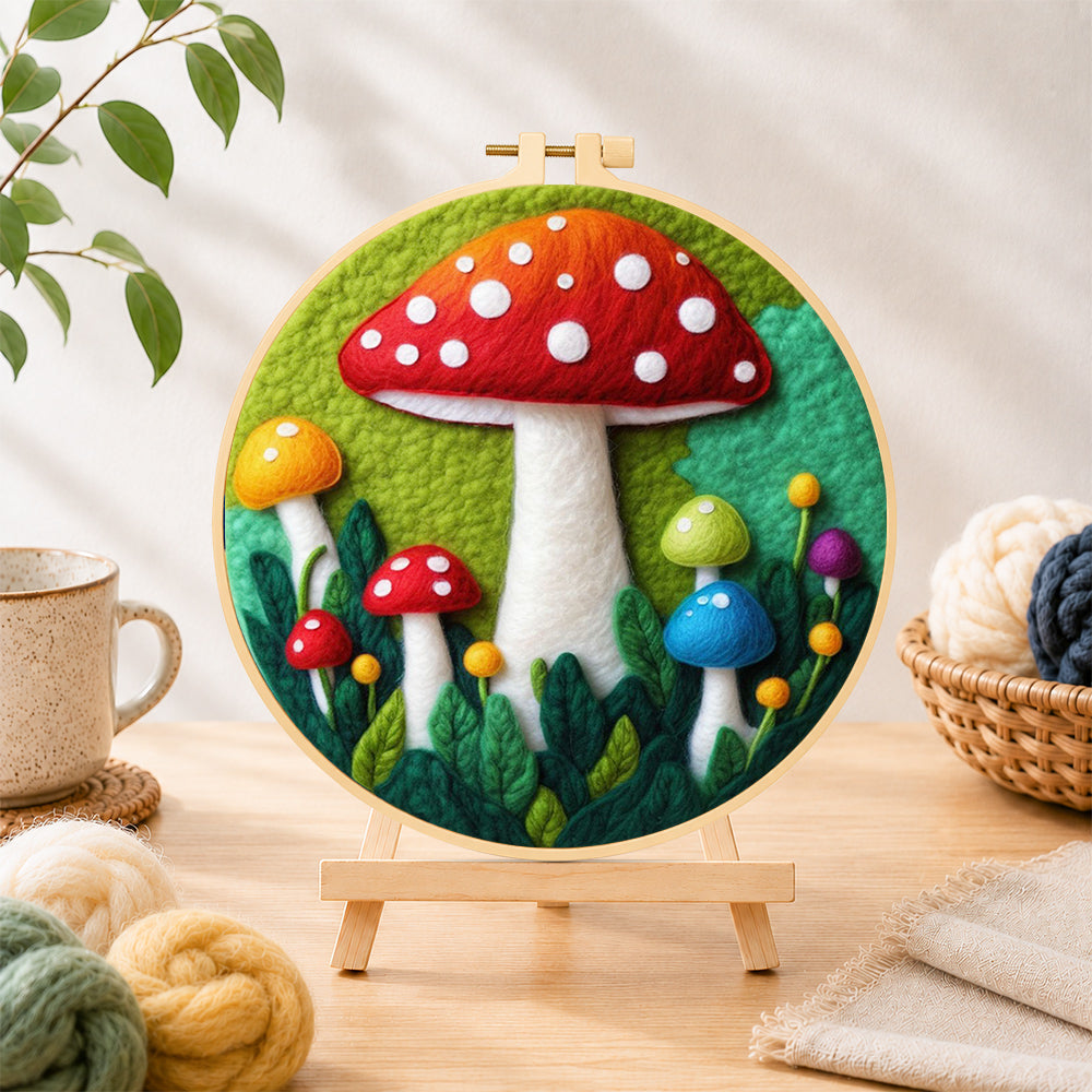 Finished giant red mushroom in leaves needle felting displayed on a wooden easel