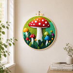 Giant red mushroom in leaves needle felt wall art displayed in a bright home interior