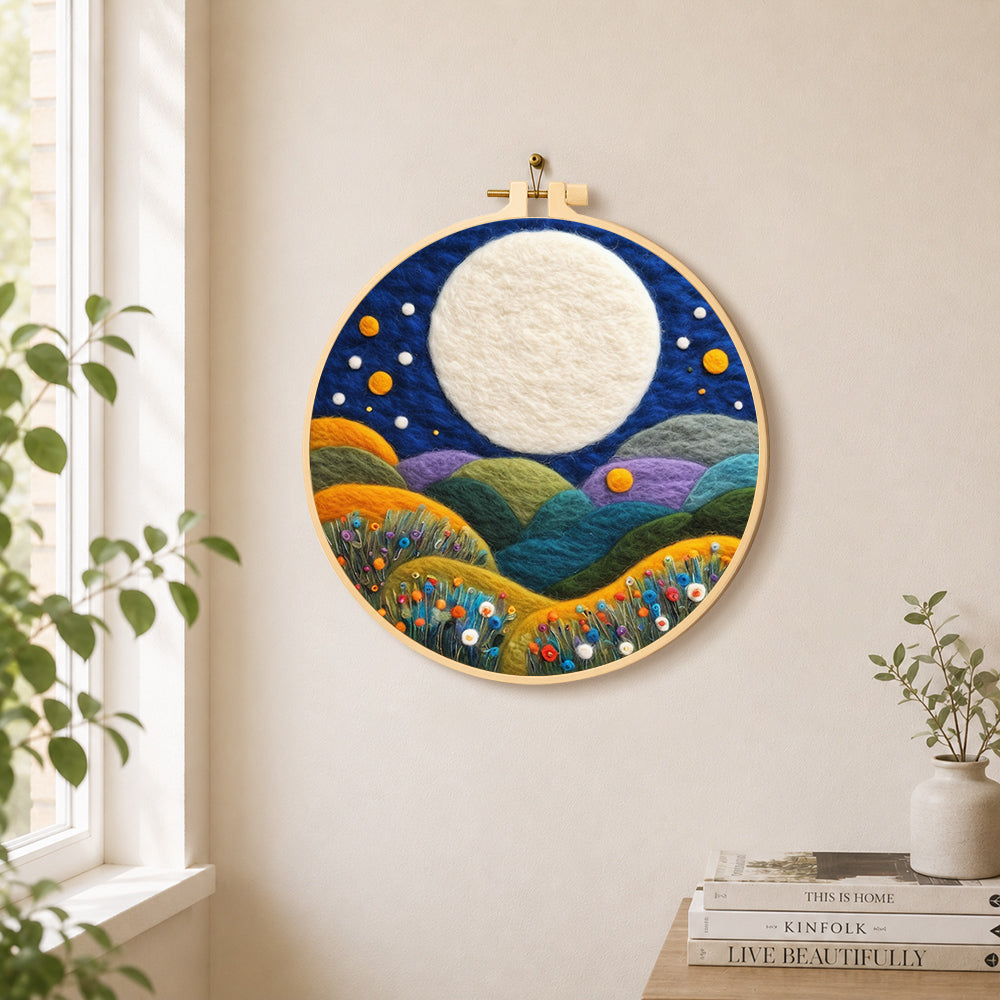 Giant white moon over colourful flower hills needle felt wall art displayed in a bright home interior