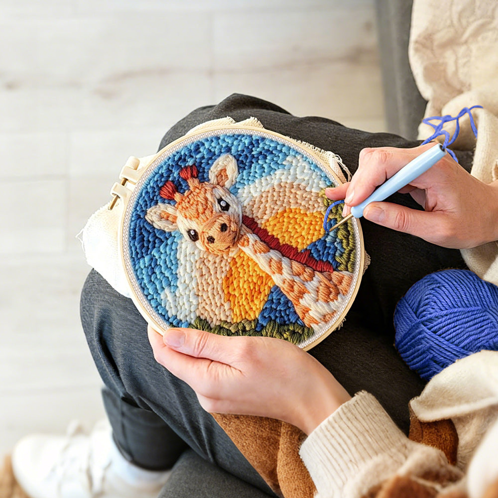 Creating handmade giraffe at sunset punch needle artwork