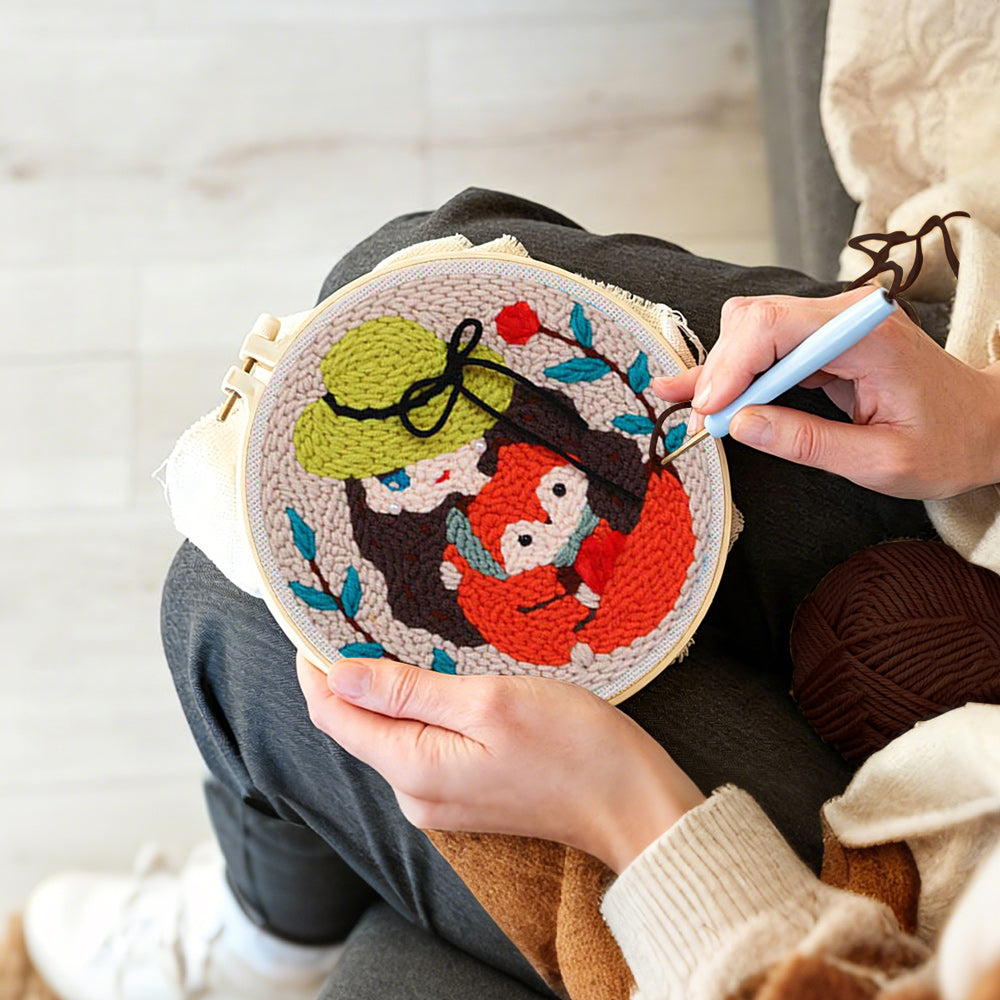 Creating handmade girl holding fox punch needle artwork