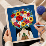 Creating handmade girl holding giant flower bunch punch needle artwork
