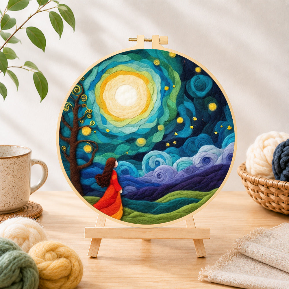 Finished girl in red dress under swirling starry night needle felting displayed on a wooden easel