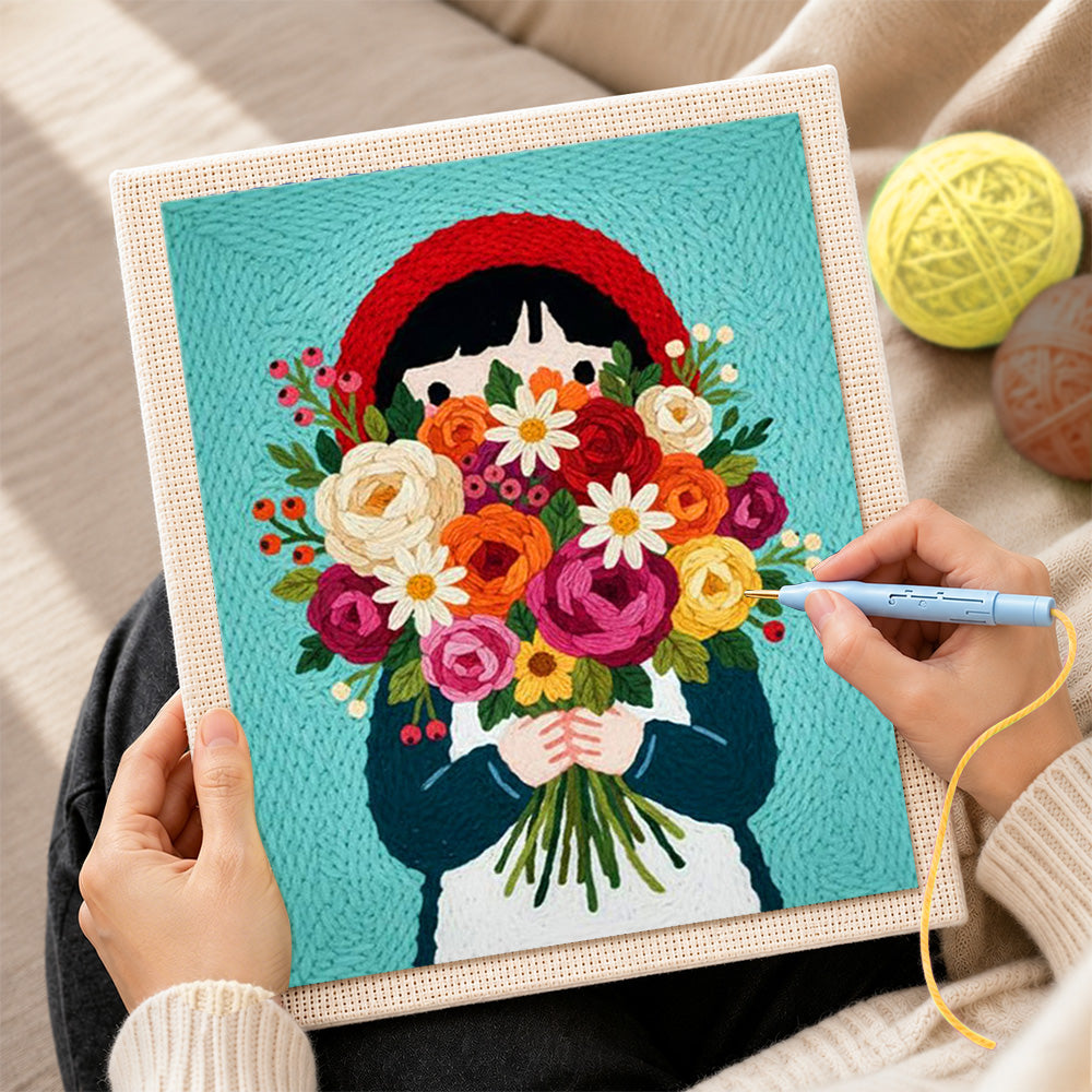 Creating handmade girl in red headscarf holding flowers punch needle artwork