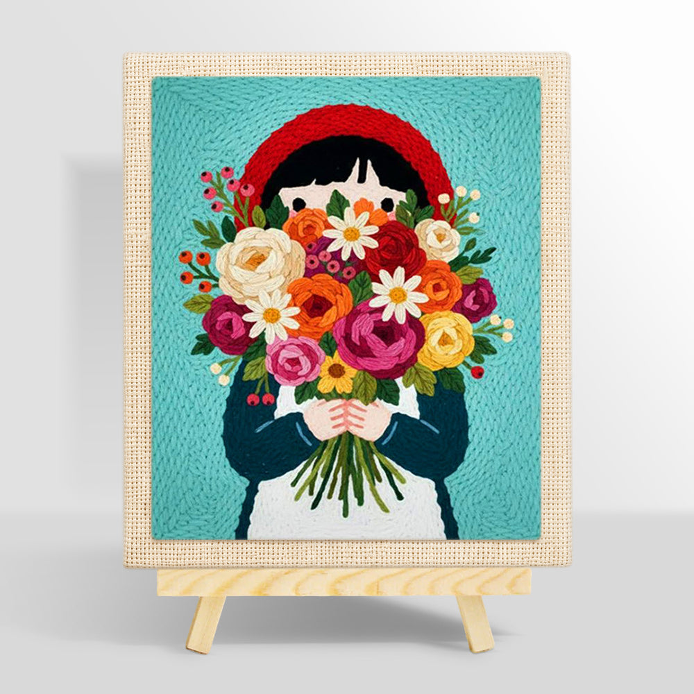 Girl in red headscarf holding flowers punch needle kit for beginners