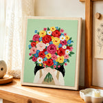 Girl with bright flower bouquet punch needle artwork displayed on a table