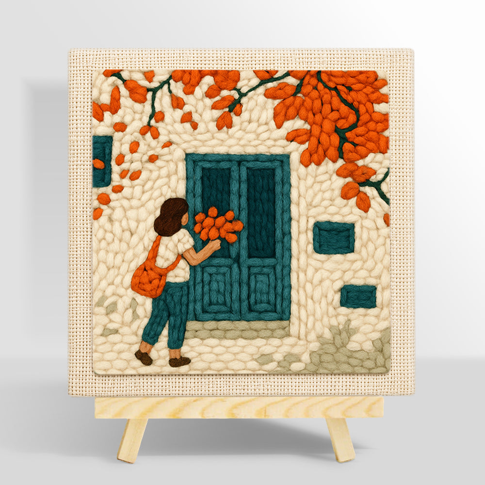 Girl with orange leaves at blue door punch needle kit for beginners