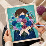Creating handmade girl with romantic flower bunch punch needle artwork