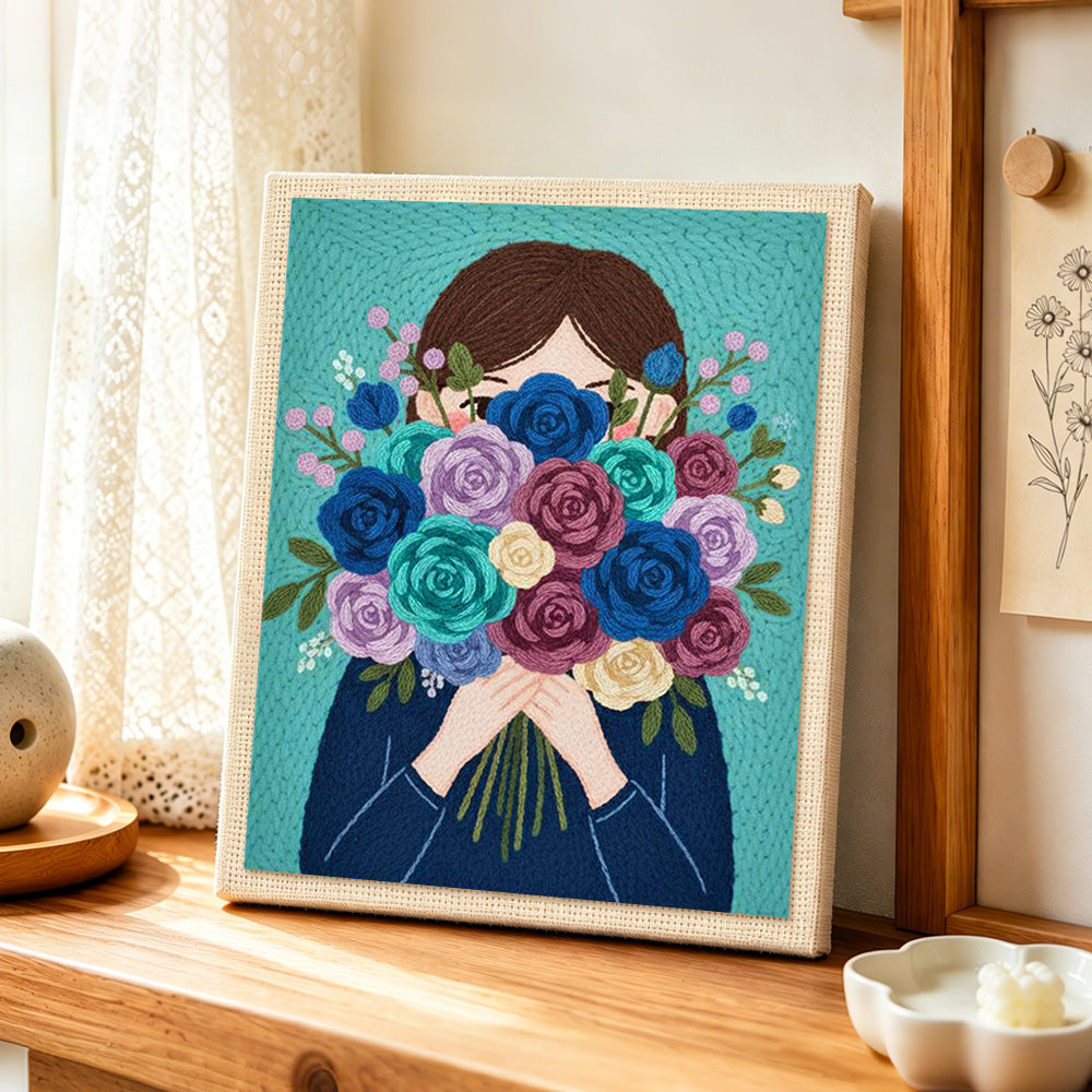 Girl with romantic flower bunch punch needle artwork displayed on a table