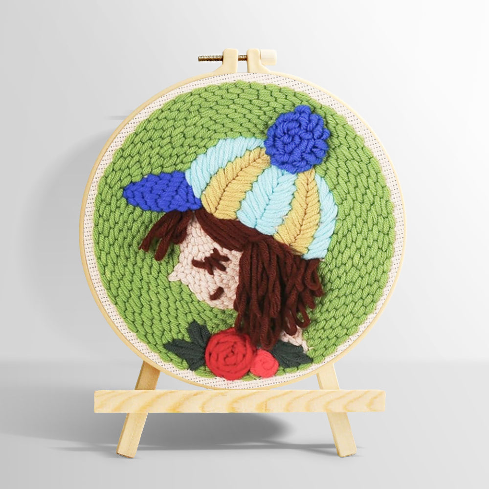 Girl with striped beanie and rose punch needle kit for beginners