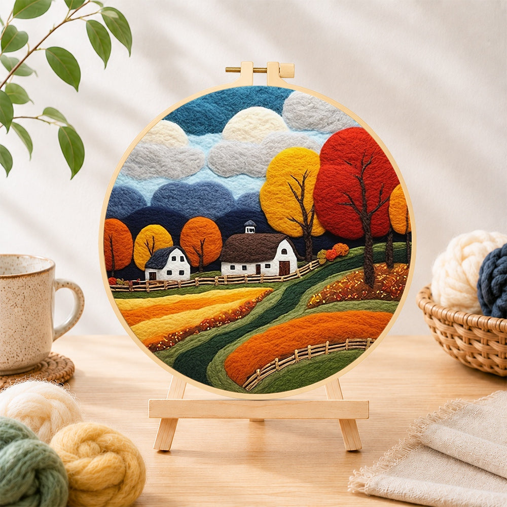 Finished golden autumn tree and rolling hills needle felting displayed on a wooden easel