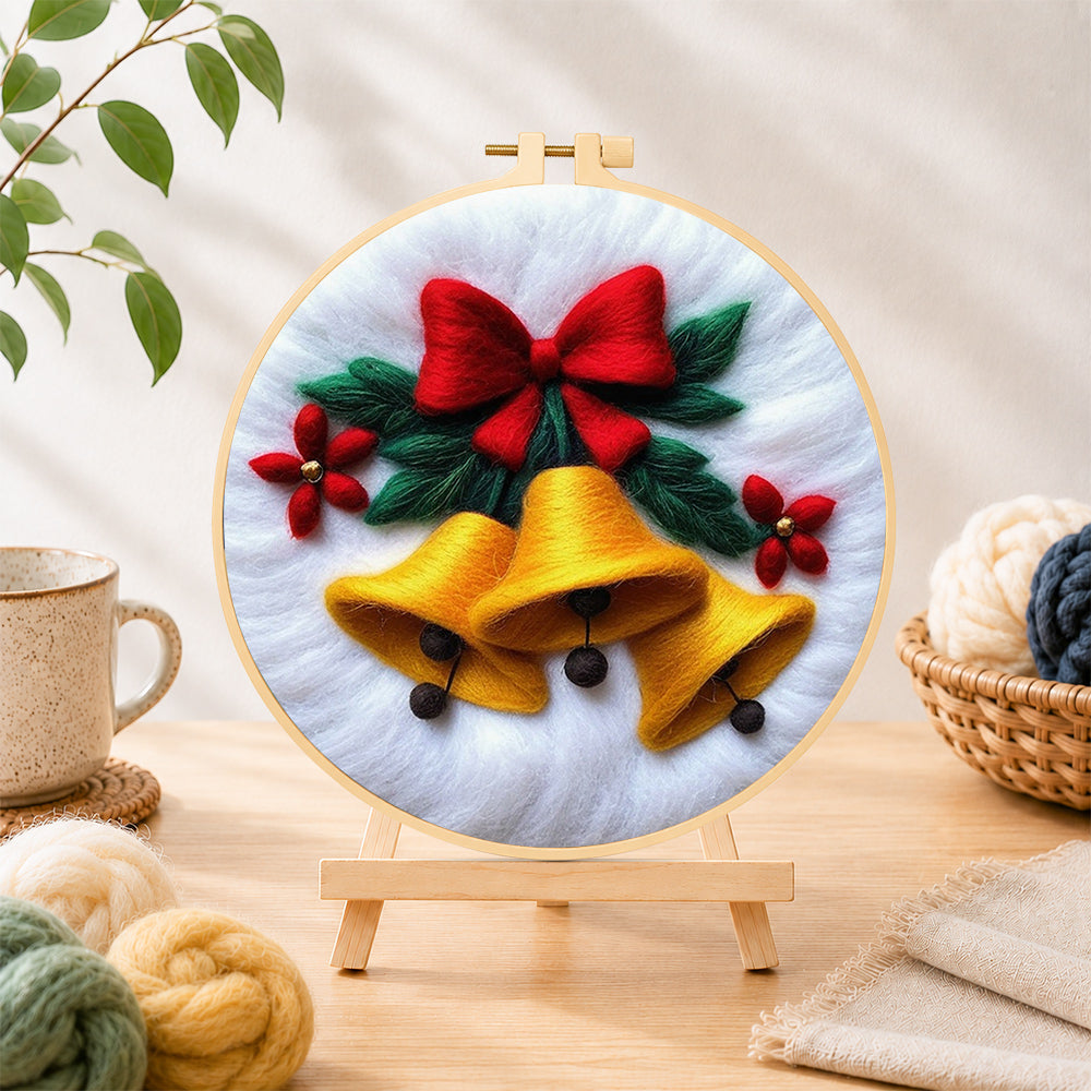 Finished golden christmas bells with red bow needle felting displayed on a wooden easel