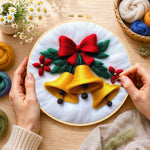 Creating the golden christmas bells with red bow wool painting by hand with a felting needle