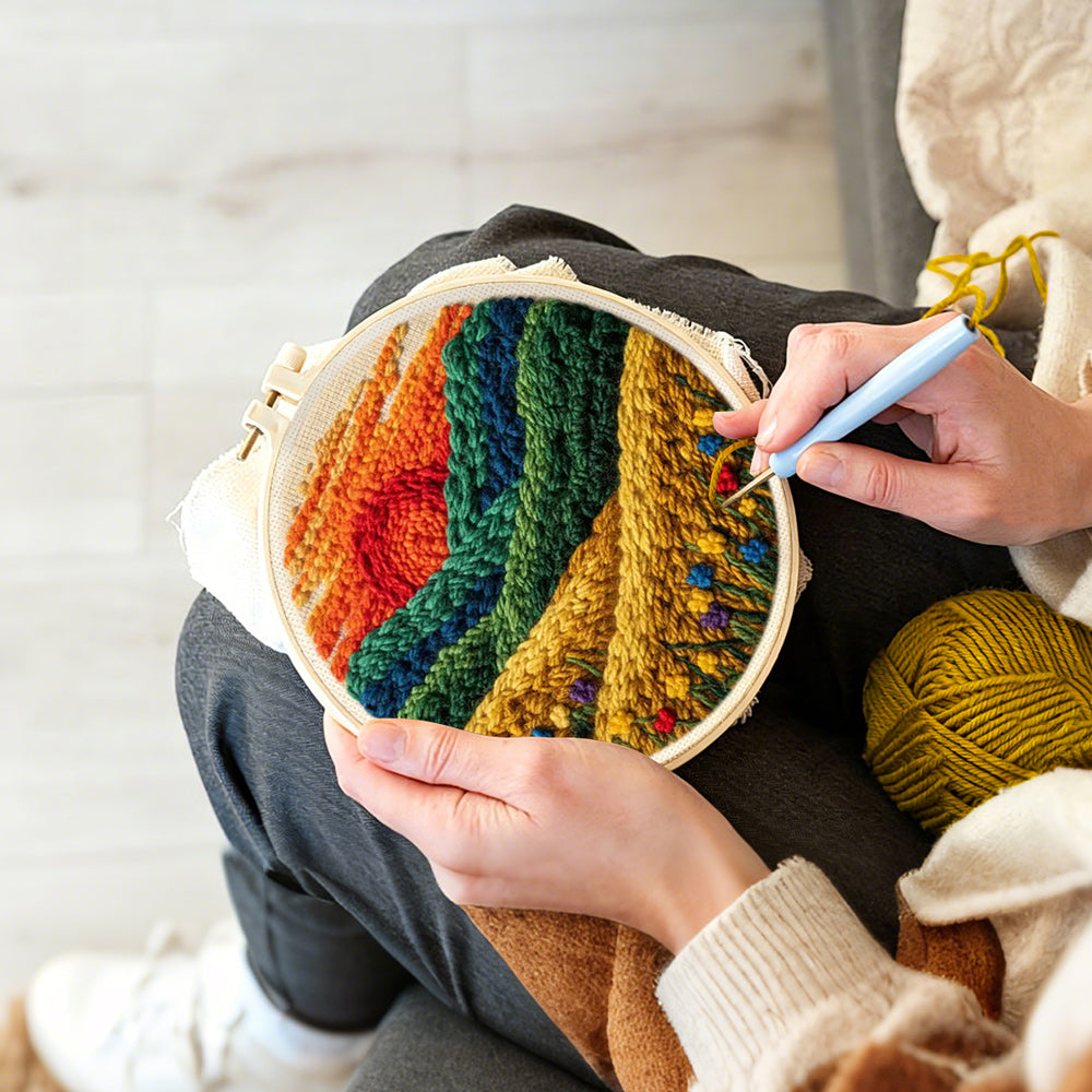 Creating handmade golden field and green hills at sunset punch needle artwork